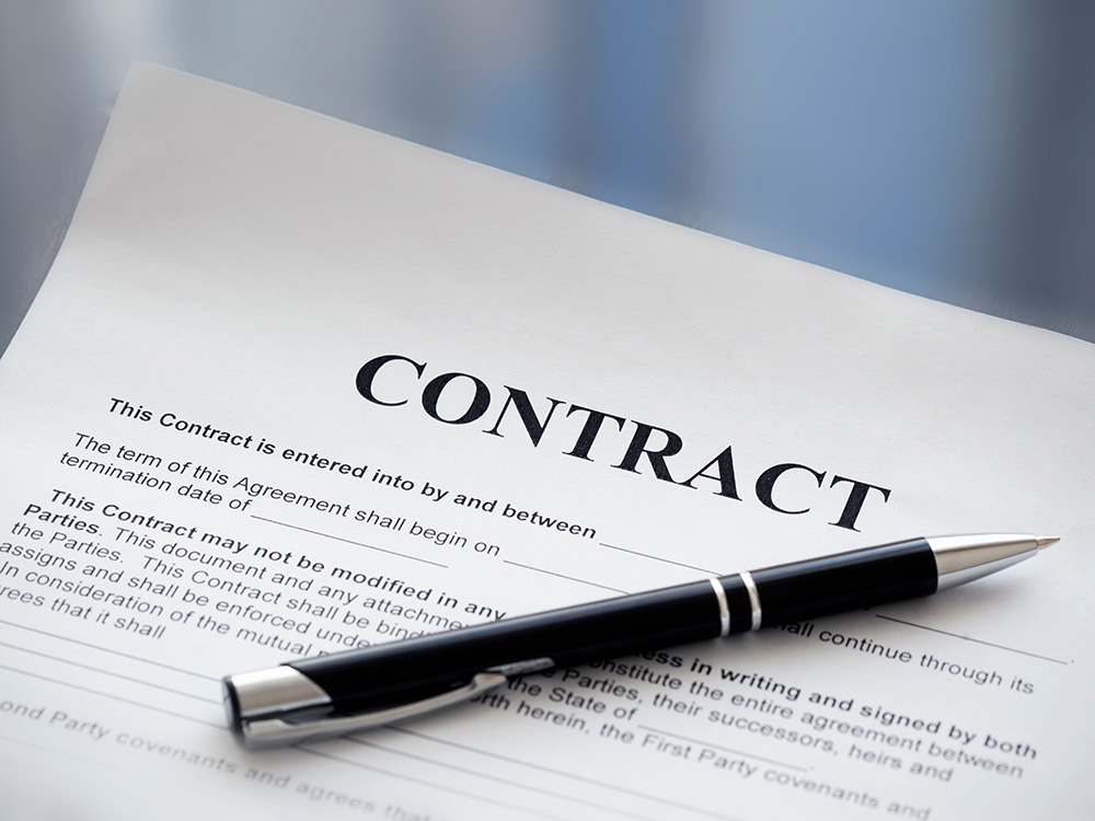 Close-up of a contract document with a pen placed on top